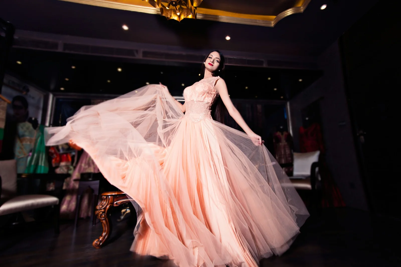 Elegant model in a flowing gown accompanying the Angels of P application page